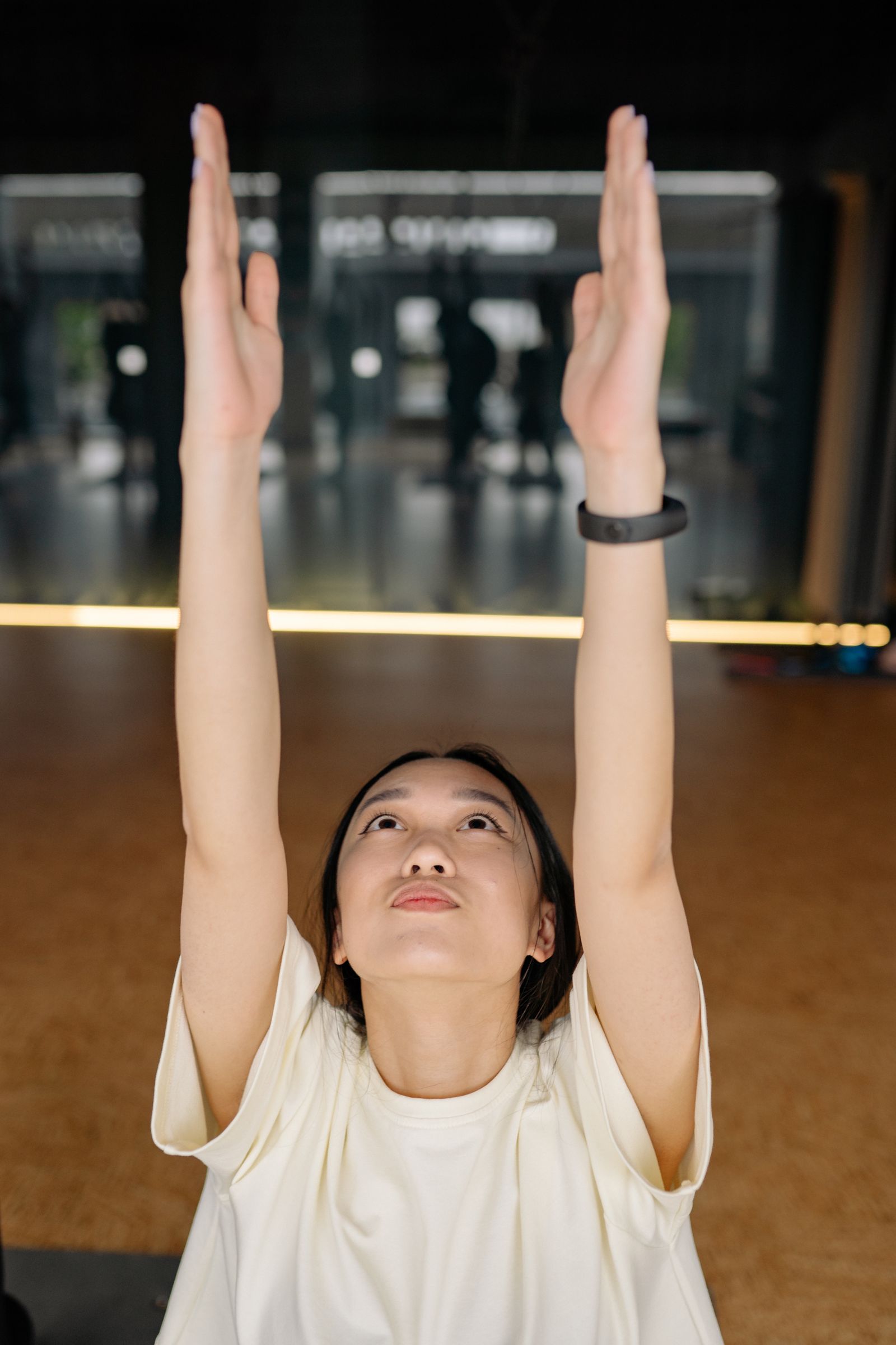 Yoga student reaching upward in the YogaaBlissLife studio