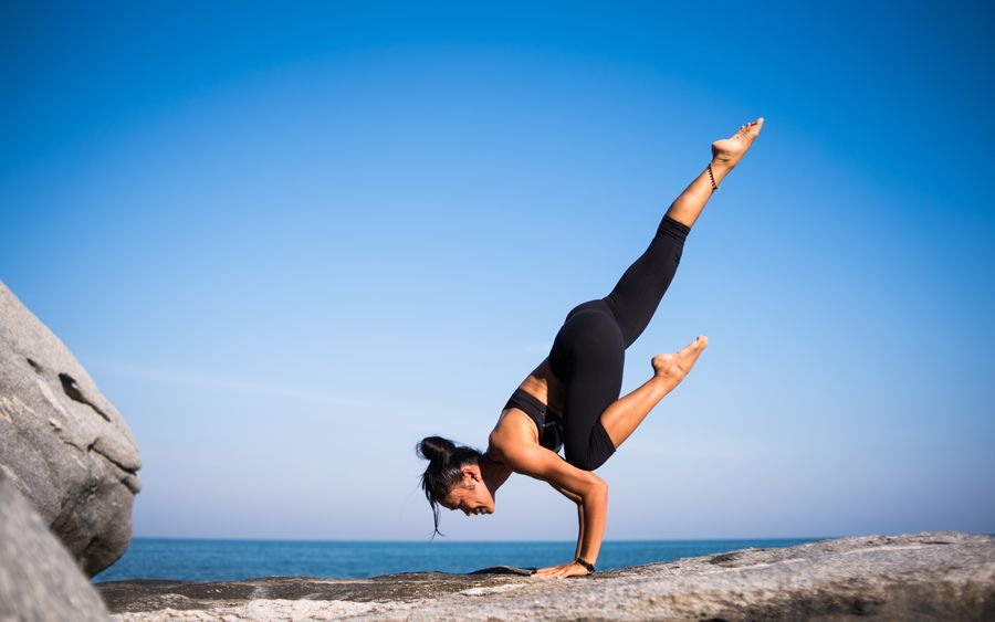Student in a hatha yoga pose by the ocean