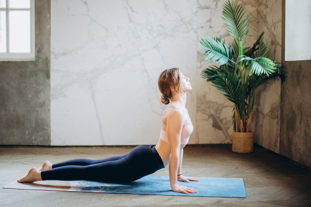 Private yoga instruction in cobra pose